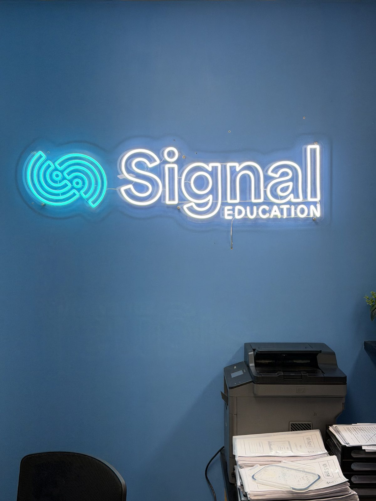 The Signal Education neon sign inside the centre